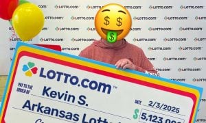 Kevin S holds up his winning arkansas lotto check courtesy of courier lotto com