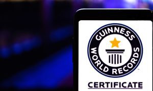 a mobile phone with a guiness world record certificate image on it