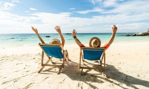 Two excited people enjoying a beach vacation
