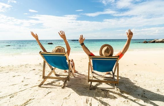 Two excited people enjoying a beach vacation