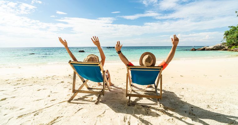 Two excited people enjoying a beach vacation