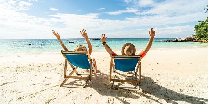 Two excited people enjoying a beach vacation