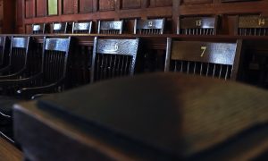 Numbered chairs in jury box in courtroom