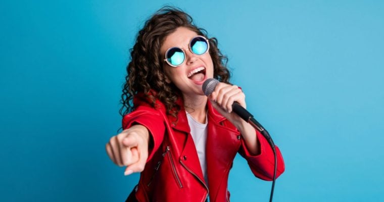 a woman signing in front of a blue background