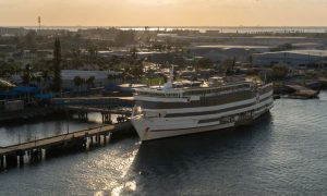 a cruise ship awaiting takeoff from a dock