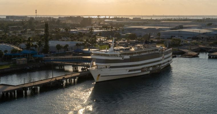 a cruise ship awaiting takeoff from a dock