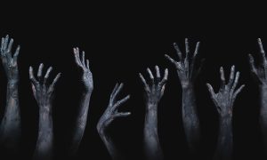 grasping zombie hands horror theme