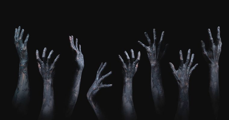 grasping zombie hands horror theme