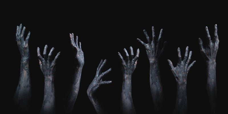 grasping zombie hands horror theme