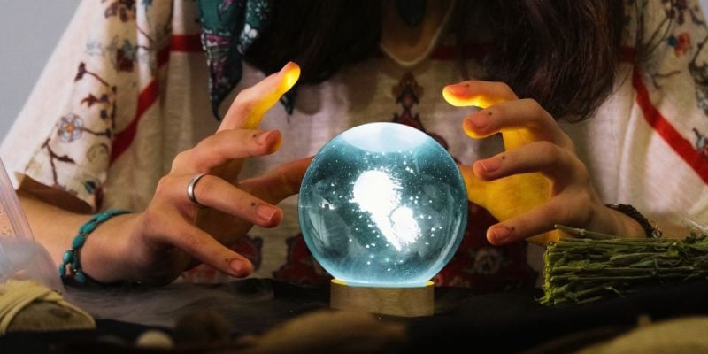 a person looking into a crystal ball