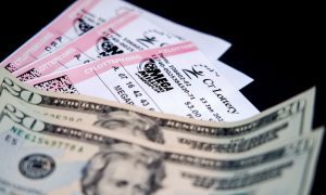 a trio of mega millions tickets next to two twenty dollar bills