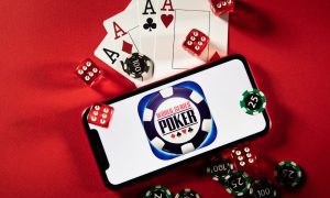 a mobile phone with the wsop logo surrounded by cards dice and chips