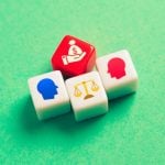 4 Dice Depict Legal Battle With Heads, Scale & Hand Holding Money Bag