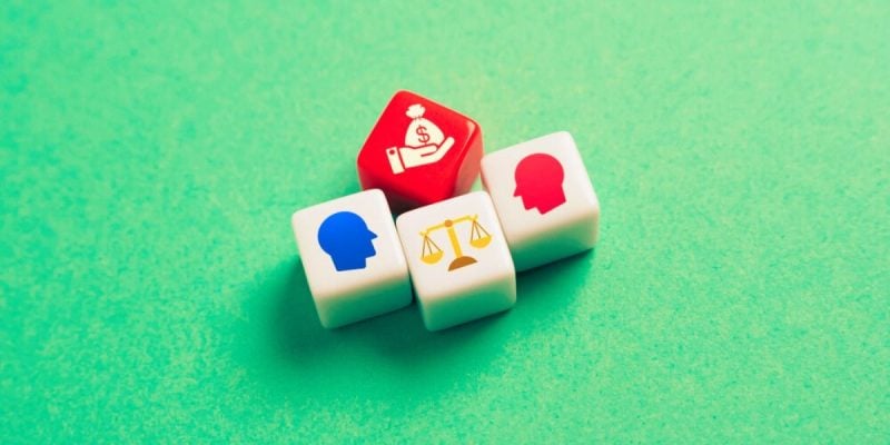 4 Dice Depict Legal Battle With Heads, Scale & Hand Holding Money Bag