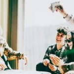 Friends Have Fun Playing Cards At a Table