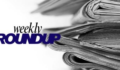 Stacked Newspapers With Weekly Roundup Text Overlay