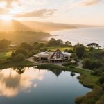 Tribal Casino Sits On Bank of Beautiful Lake Surrounded By Trees and Sun Setting Background