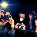 Three Paparazzi Point Flashing Cameras Inside a Car