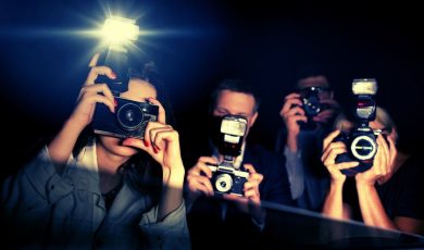 Three Paparazzi Point Flashing Cameras Inside a Car