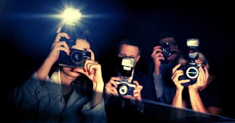 Three Paparazzi Point Flashing Cameras Inside a Car