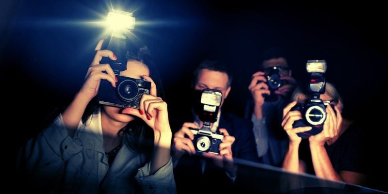 Three Paparazzi Point Flashing Cameras Inside a Car