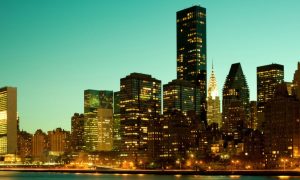 A Green Evening Sky Backdrops a Lit Up NYC Skyline