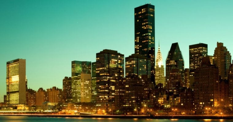 A Green Evening Sky Backdrops a Lit Up NYC Skyline