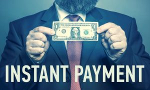 Man Holds Dollar In Cash with Phrase Instant Payment Below