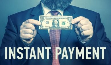 Man Holds Dollar In Cash with Phrase Instant Payment Below