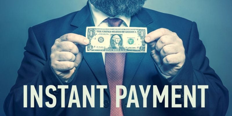 Man Holds Dollar In Cash with Phrase Instant Payment Below