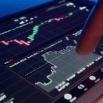 Digital Financial Graphs On Tablet With Finger