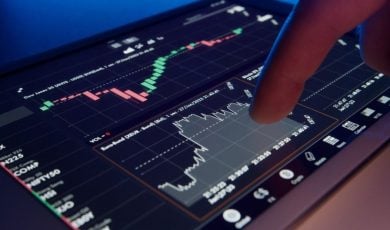 Digital Financial Graphs On Tablet With Finger