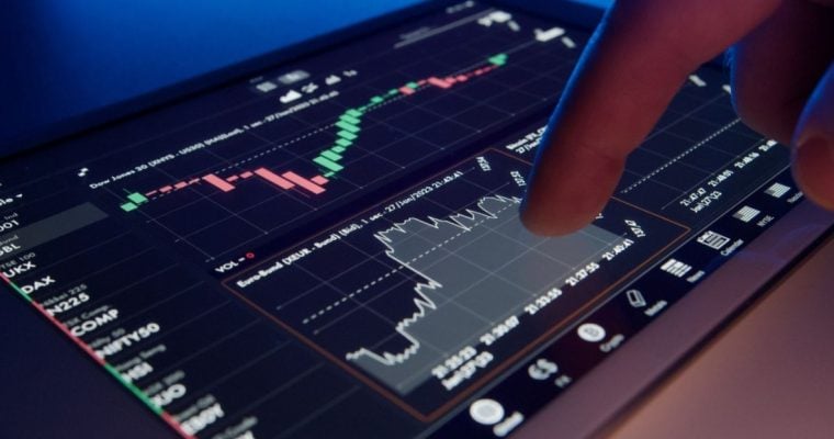 Digital Financial Graphs On Tablet With Finger