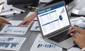 People Work On Financial Plans On Desk with Papers