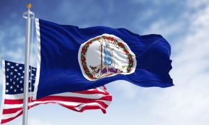 American Flag Behind Virginia Flag Waving in Blue Skies
