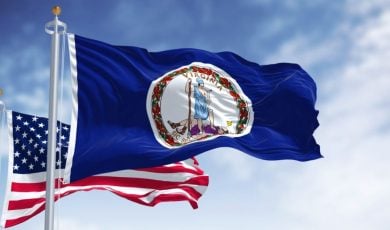 American Flag Behind Virginia Flag Waving in Blue Skies