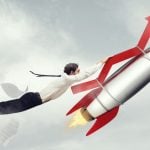 Red Financial Arrow Attached to Rocket Soars With Man Hanging On