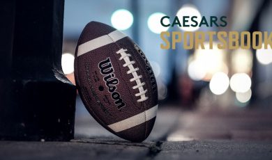 Caesars Sportsbook Logo Over Image of Standing American Football On Ground