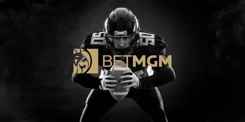 Black/White Photo of Crouching American Football Player with BetMGM Gold Logo