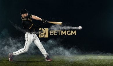 BetMGM Logo Sits Beneath Swinging Baseball Player Hitting Baseball on Field