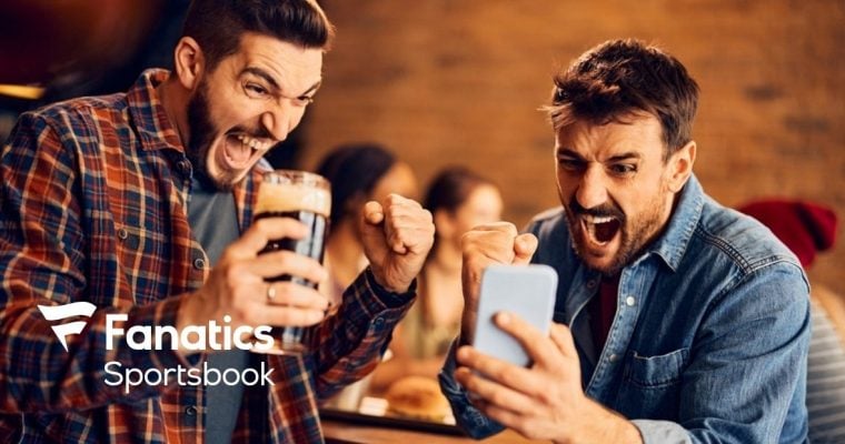Two Men Celebrate Winning Sport Bet On Cell Phone with Fanatics Sportsbook Logo