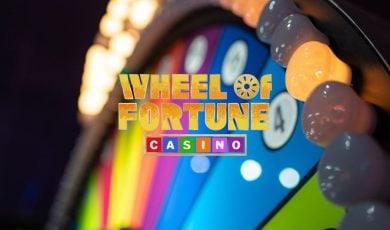 Wheel of Fortune Casino Logo Over Colorful Arcade Style Gambling Wheel