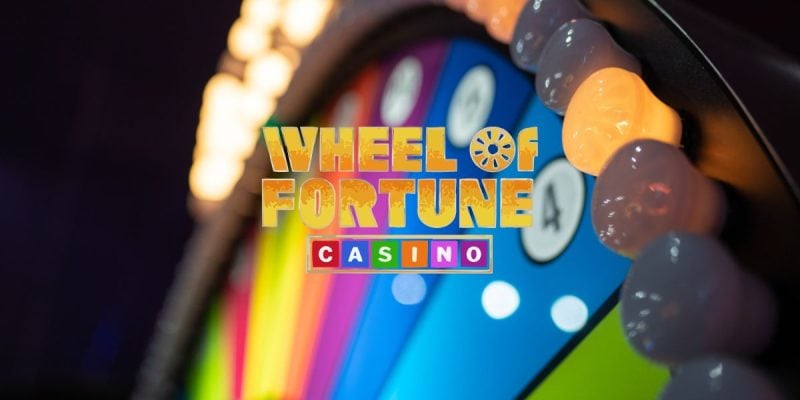 Wheel of Fortune Casino Logo Over Colorful Arcade Style Gambling Wheel