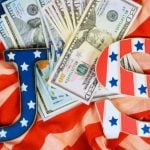 American Cash Lays On Top of the American Flag with U.S. Letters