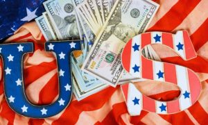 American Cash Lays On Top of the American Flag with U.S. Letters