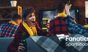 Emotional Man With Phone Cheering for Favourite Team, Celebrating Successful Betting