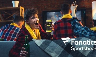 Emotional Man With Phone Cheering for Favourite Team, Celebrating Successful Betting