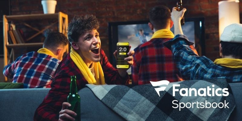 Emotional Man With Phone Cheering for Favourite Team, Celebrating Successful Betting