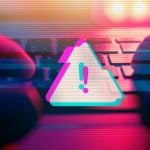 Triangle with Exclamation Mark Represents Digital Scam Warning with Hands Touching Keyboard