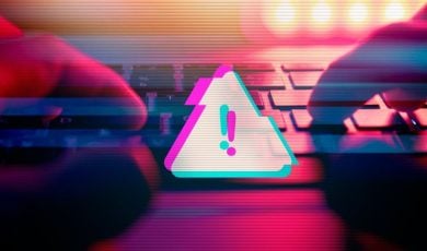 Triangle with Exclamation Mark Represents Digital Scam Warning with Hands Touching Keyboard